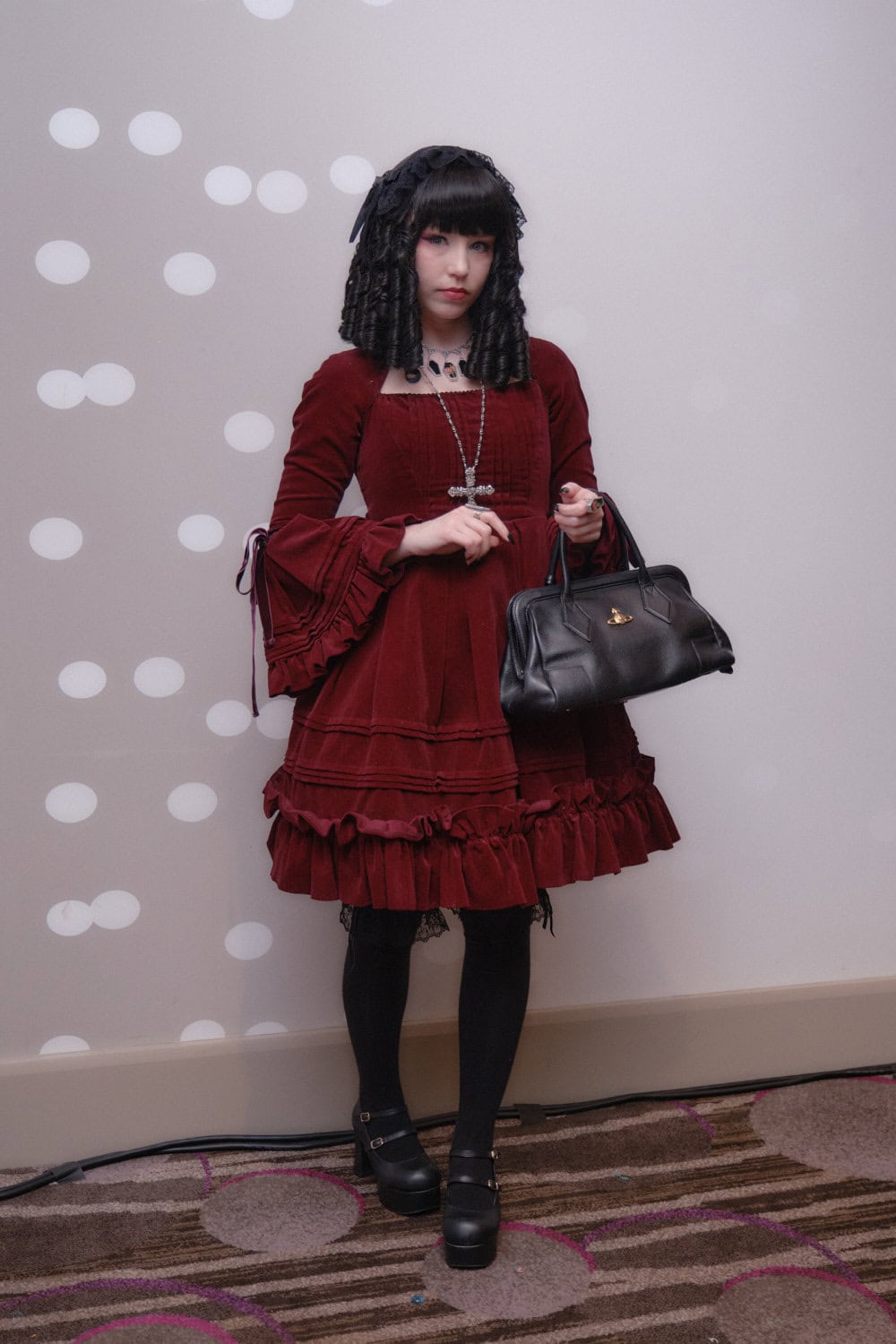 Gothic lolita wearing red velveteen dress.