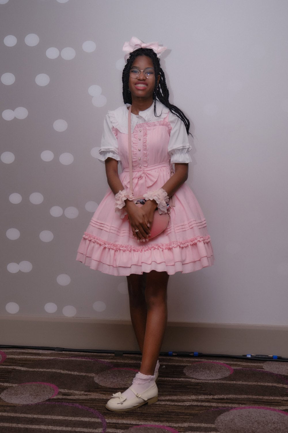 Sweet lolita wearing pink dress and white blouse.