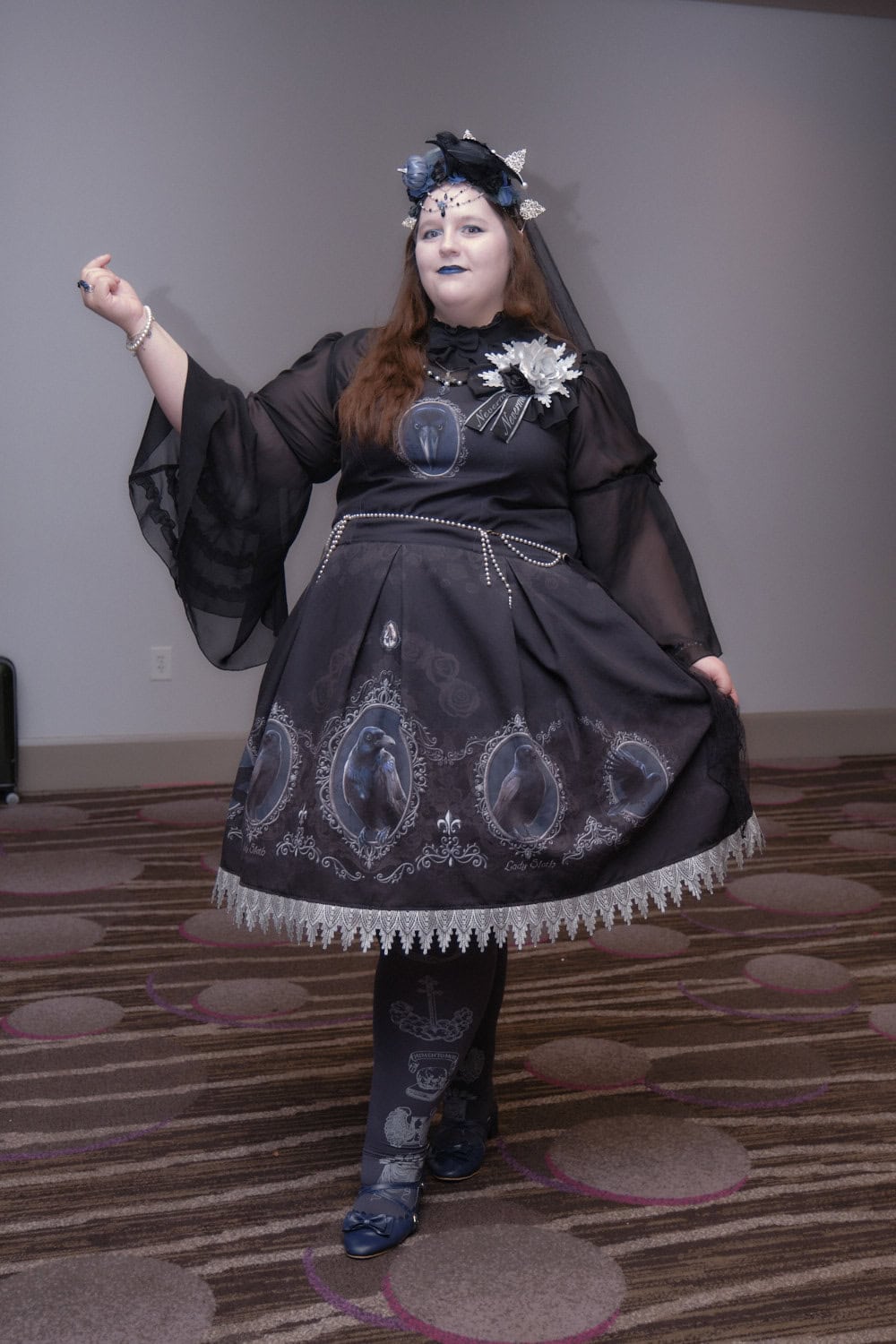 Gothic lolita wearing raven printed dress.
