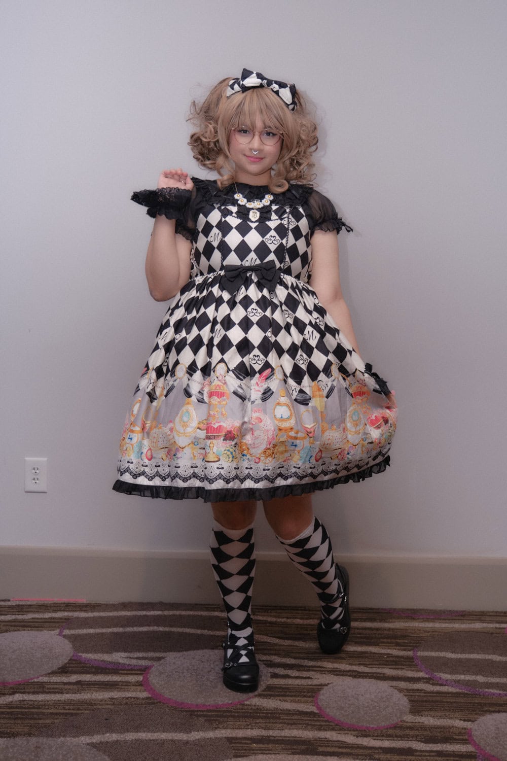 Sweet lolita wearing black and white diamond dress with matching diamond socks.