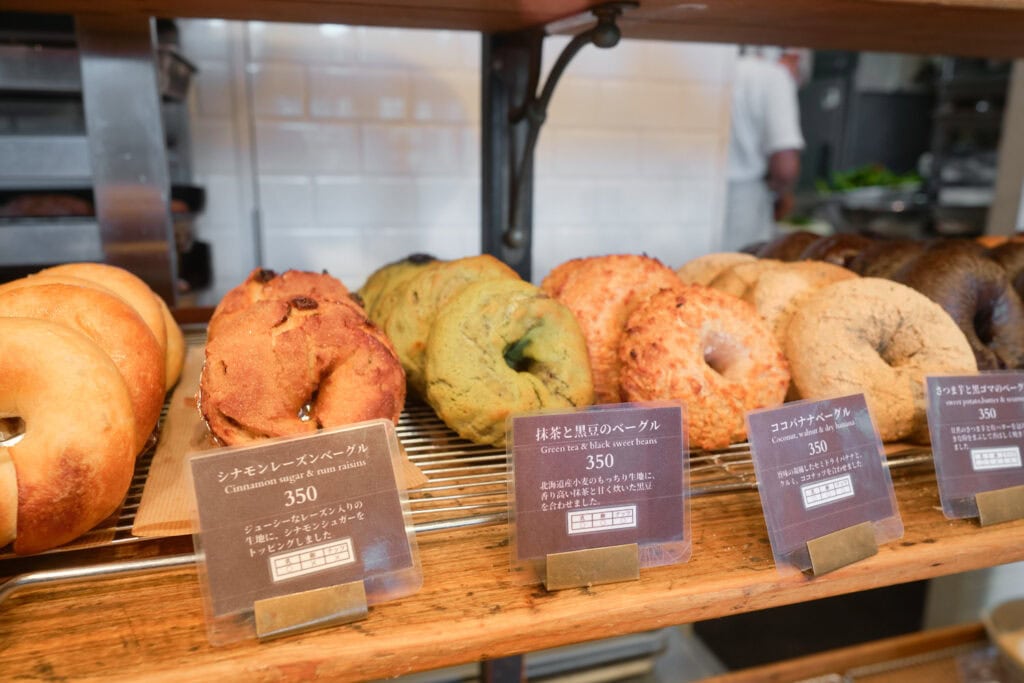 Koro Bakery's bagel selection with cinnamon sugar& rum raisin, green tea & black bean, coconut & banana, and sweet potato black sesame bagels