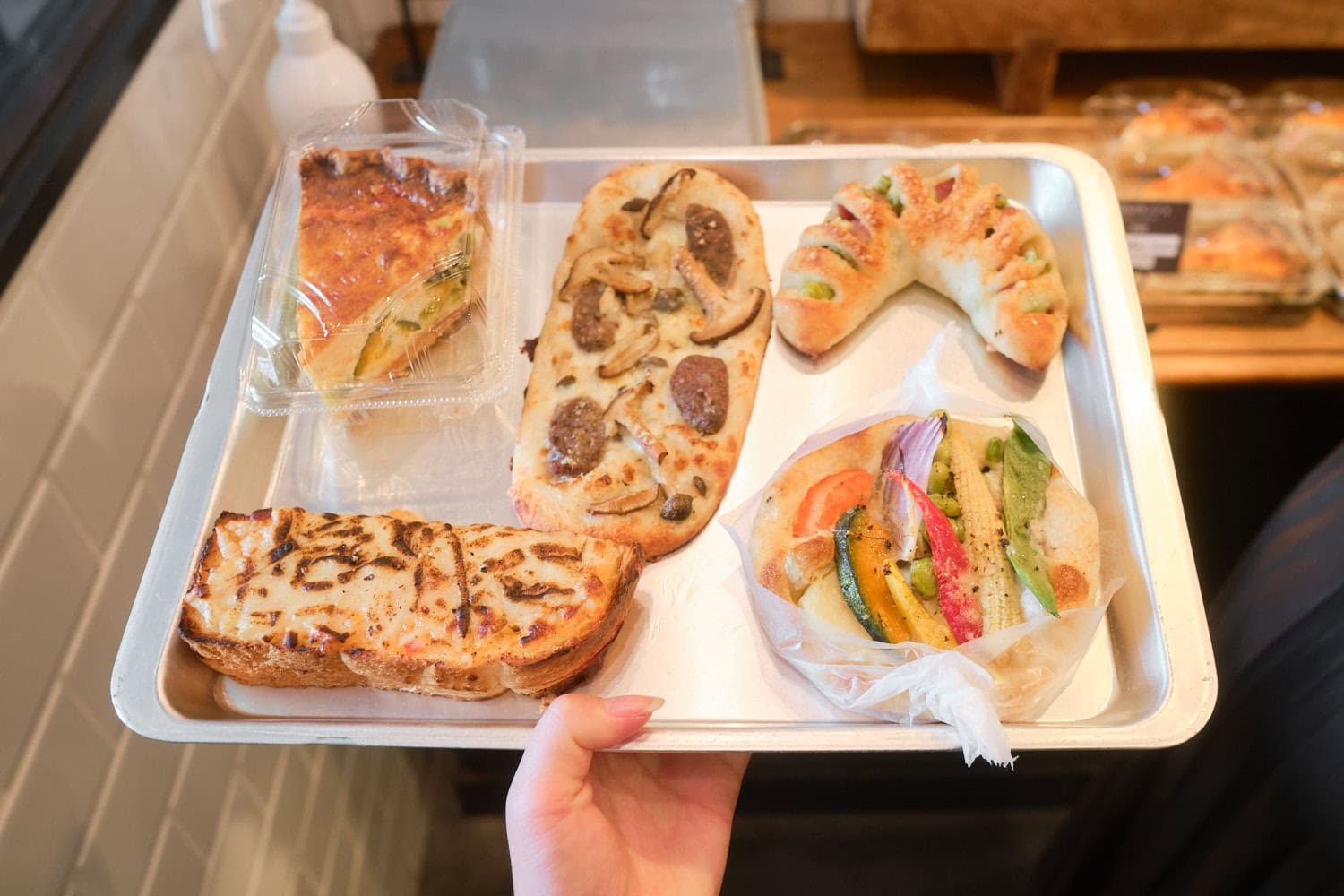 onomichi_korobakery_5 Quieche, mushroom sausage, edamame hotdog, and mixed Japanese vegetable breads on a silver tray from korobakery