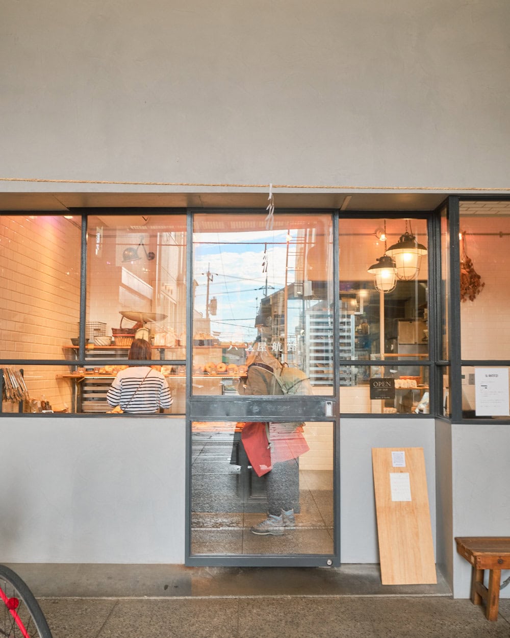 Korobakery store front with solid concrete exterior and industry black framed windows.