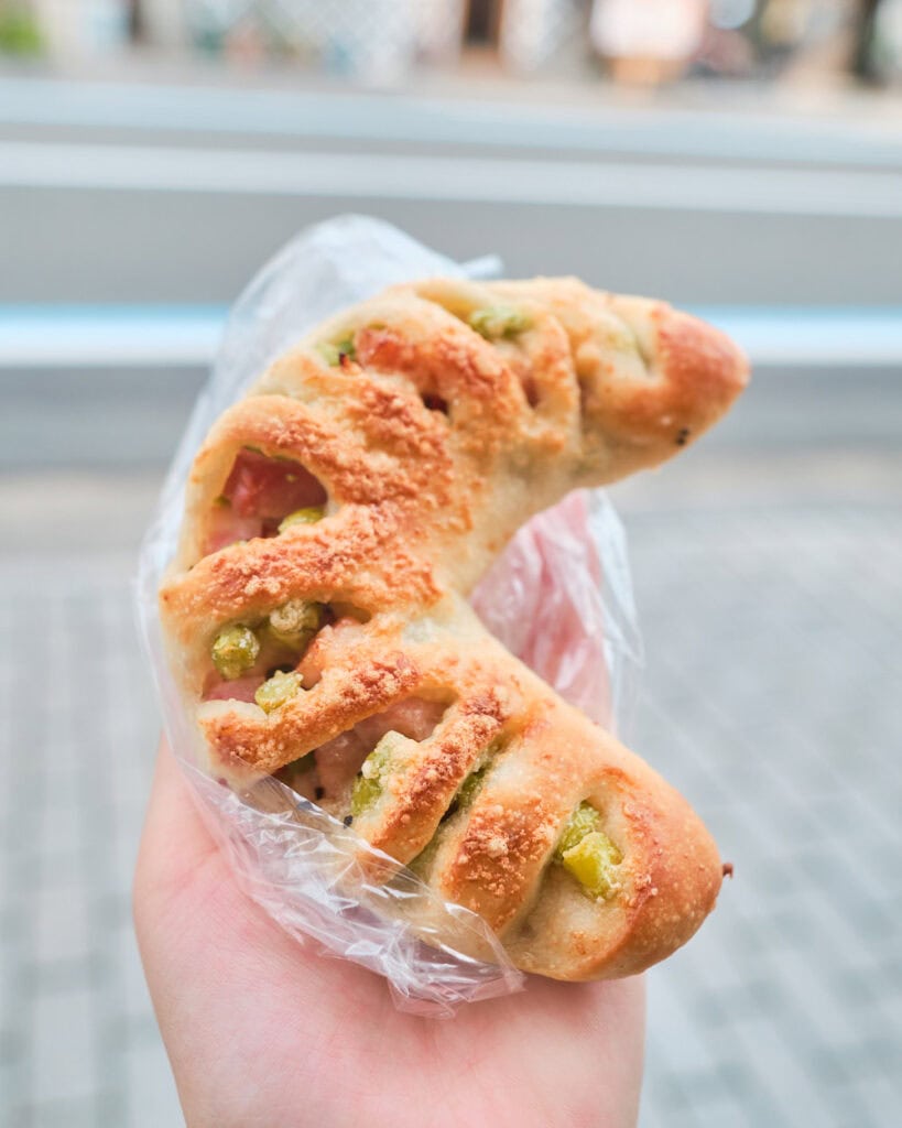 Edamame and bacon filled bread shaped like a moon from korobakery on the streets of Onomichi