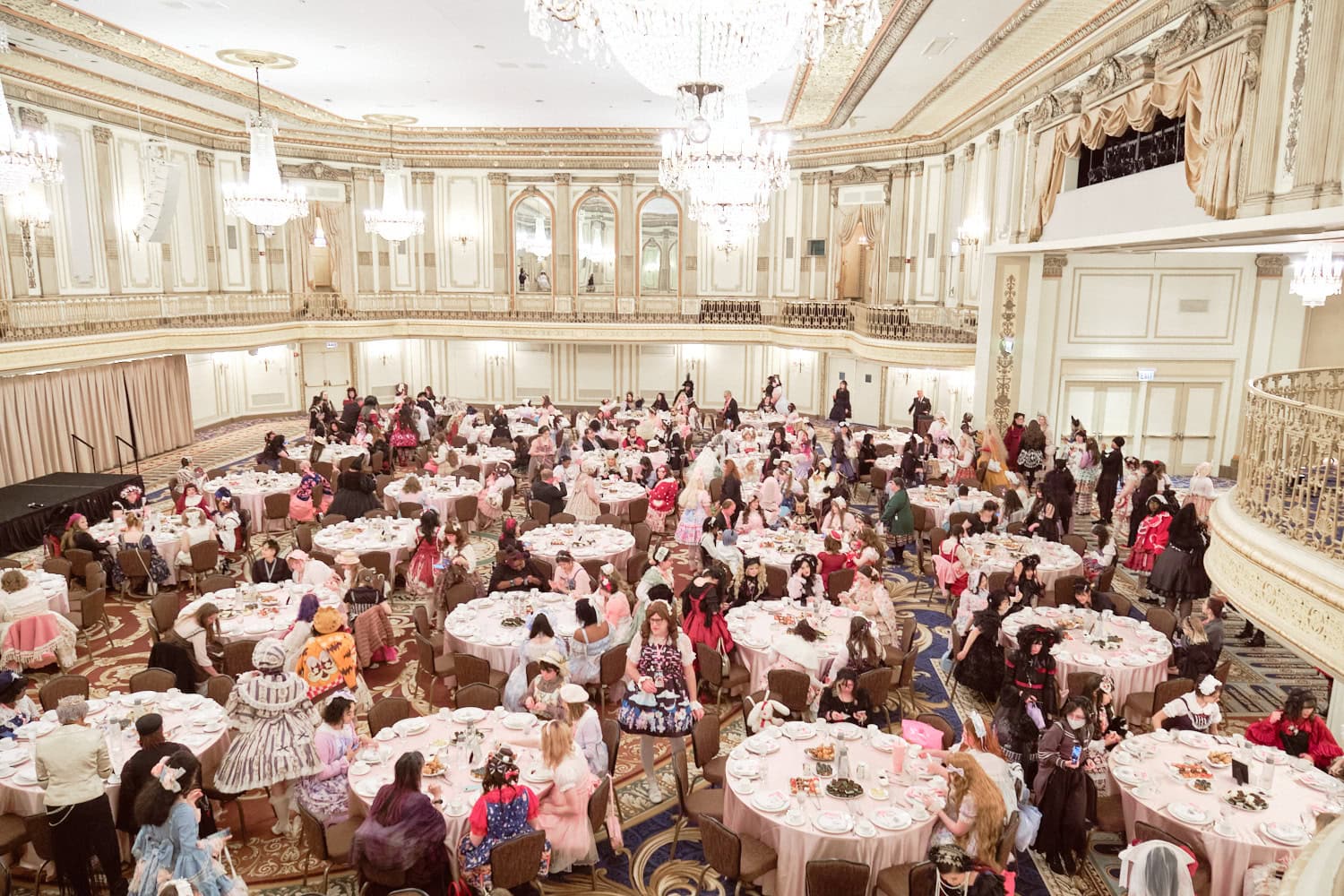 Overhead view of full tables with attendees from second floor.
