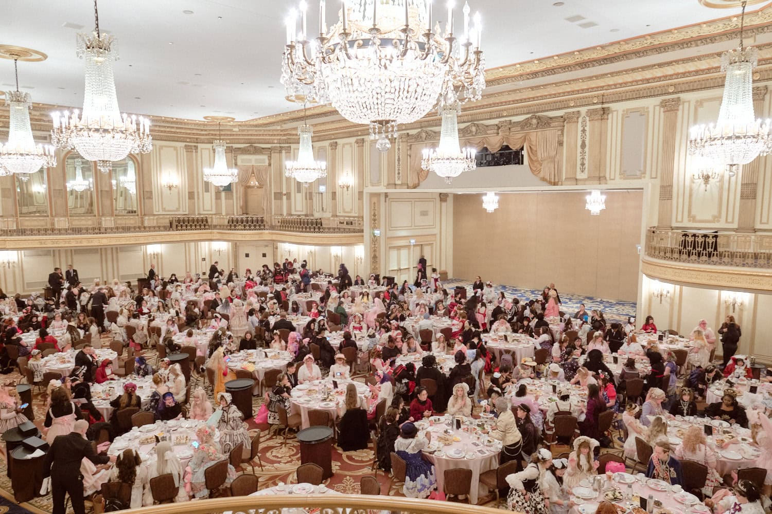 Overhead view of full tables with attendees from second floor - 2.