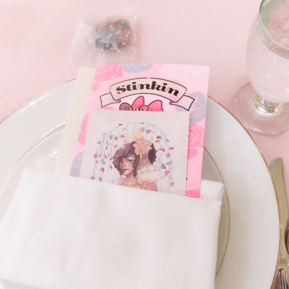 Plate with 2 post cards tucked into folded napkin.
