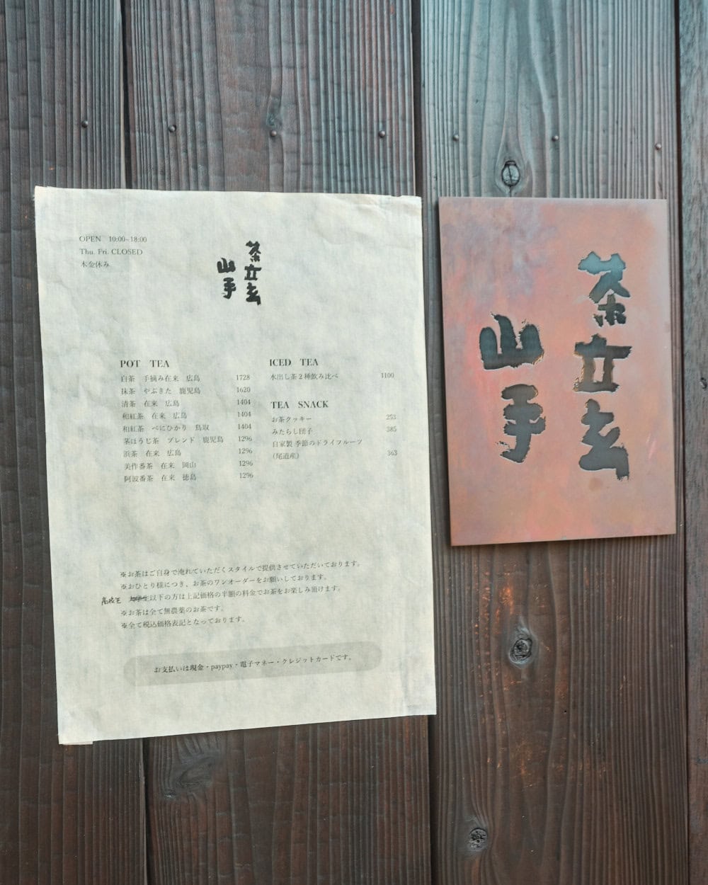 Tea Stand Yamate menu and sign on wooden exterior wall