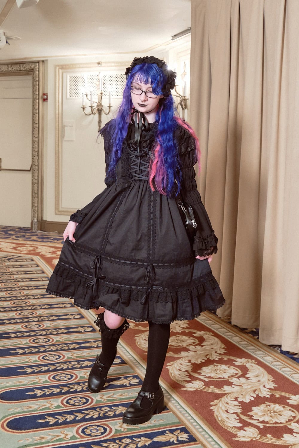 All black wearing lolita with blue and pink hair.