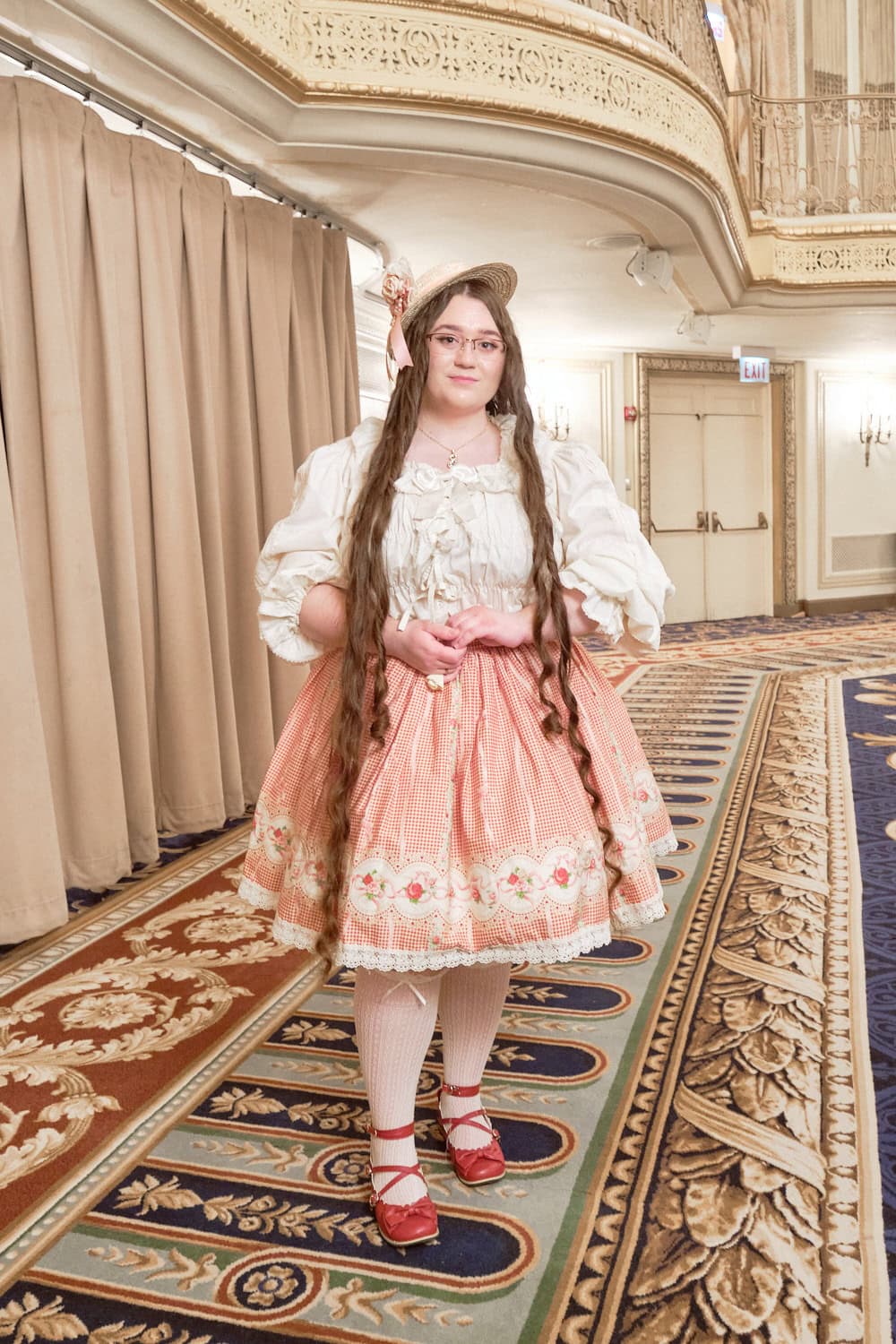 Sweet country lolita wearing white blouse, straw hat, and gingham floral skirt.