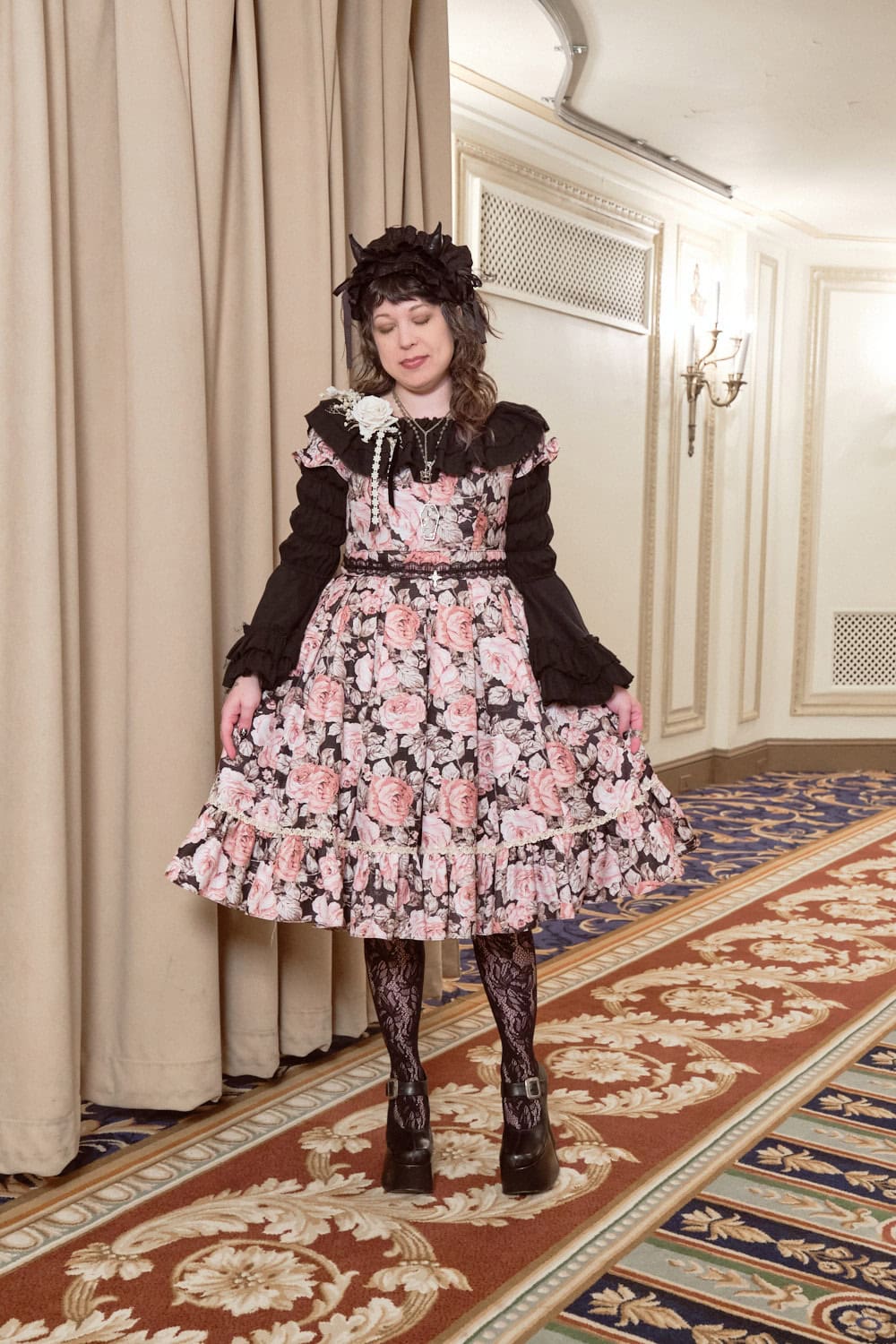 Classic lolita wearing floral dress with black blouse and tights.