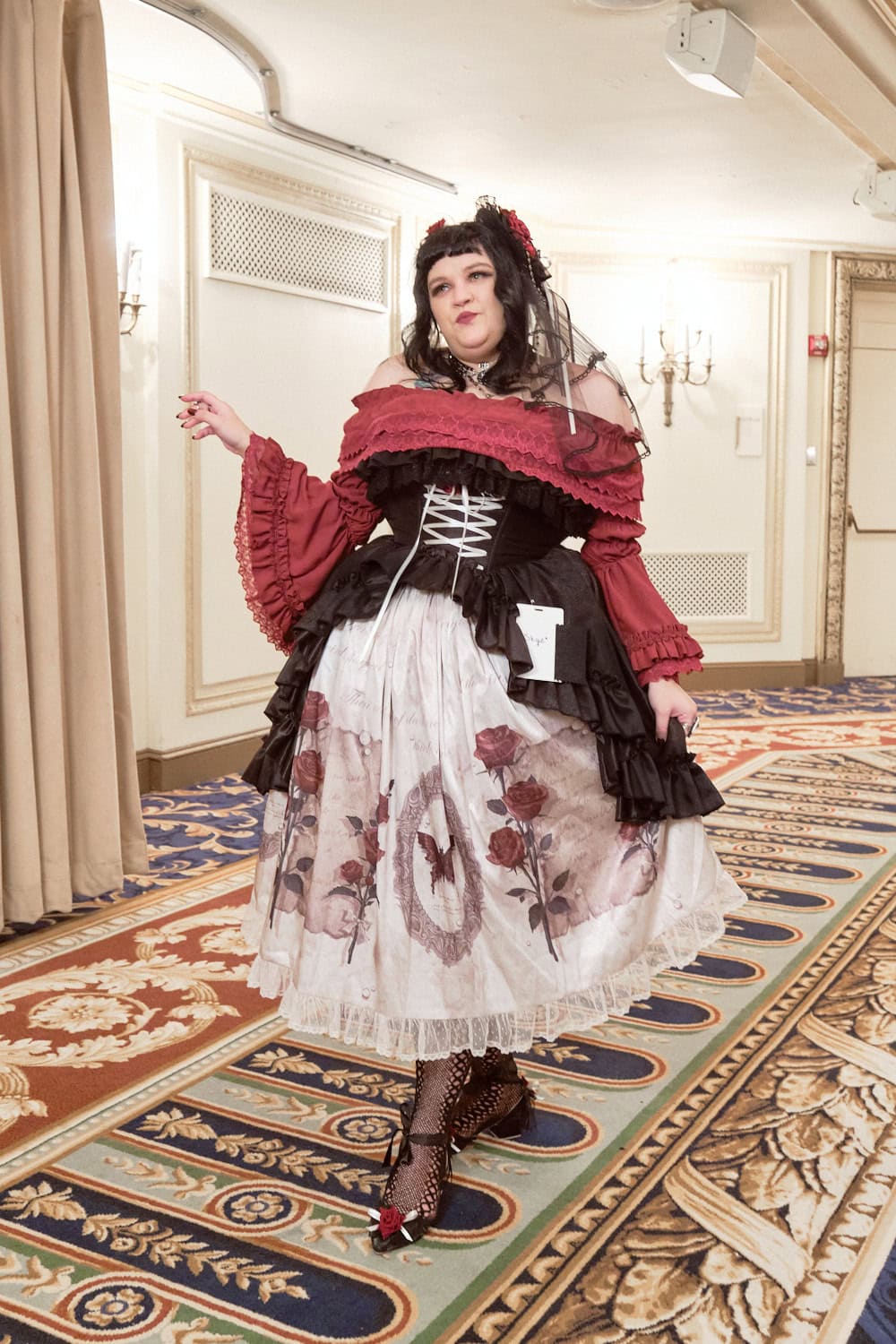 Gothic lolita wearing black and red rose themed dress.