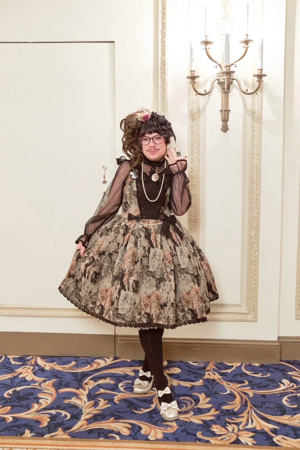 Classic lolita wearing gobelin dress with cats all over fabric.
