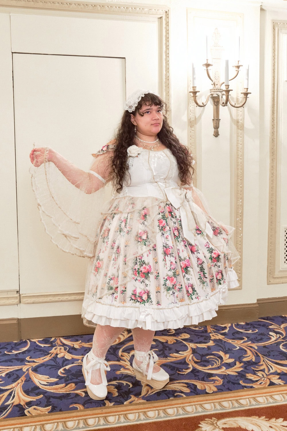 Classic lolita wearing white and cream floral print dress with lace sleeves.