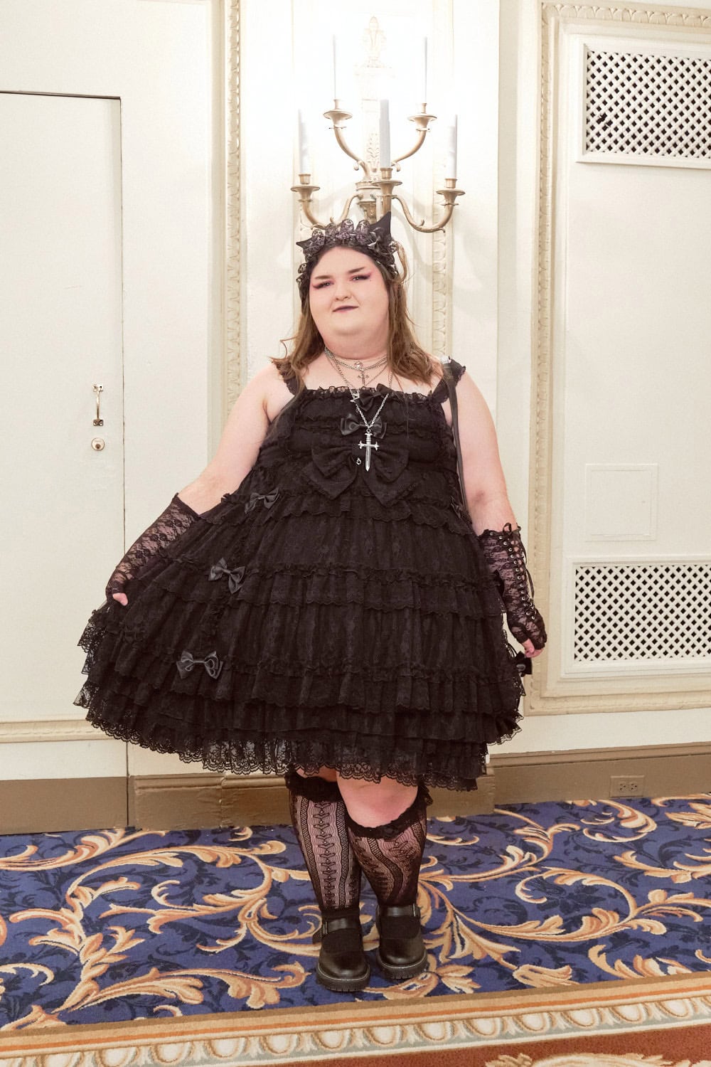 Gothic lolita wearing lace jumperskirt, lace arm warmers, and lace socks.