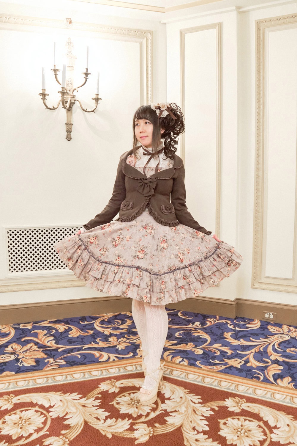 Classic lolita wearing brown blazer over printed floral dress.