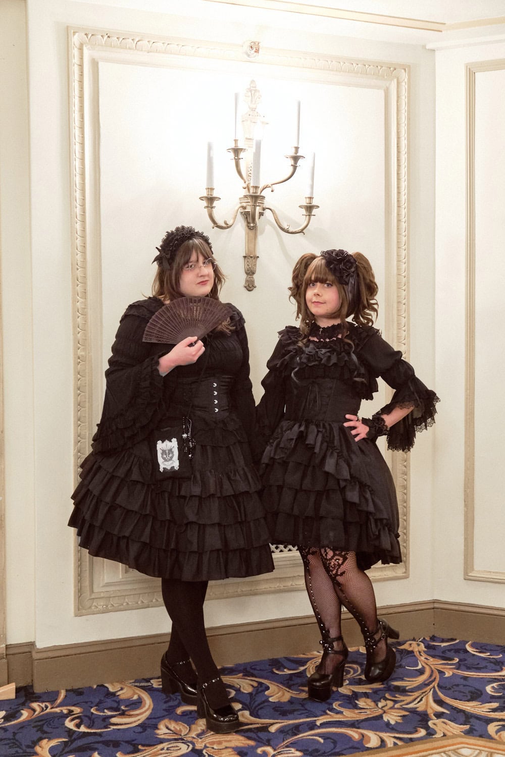 Two all black wearing gothic lolitas.