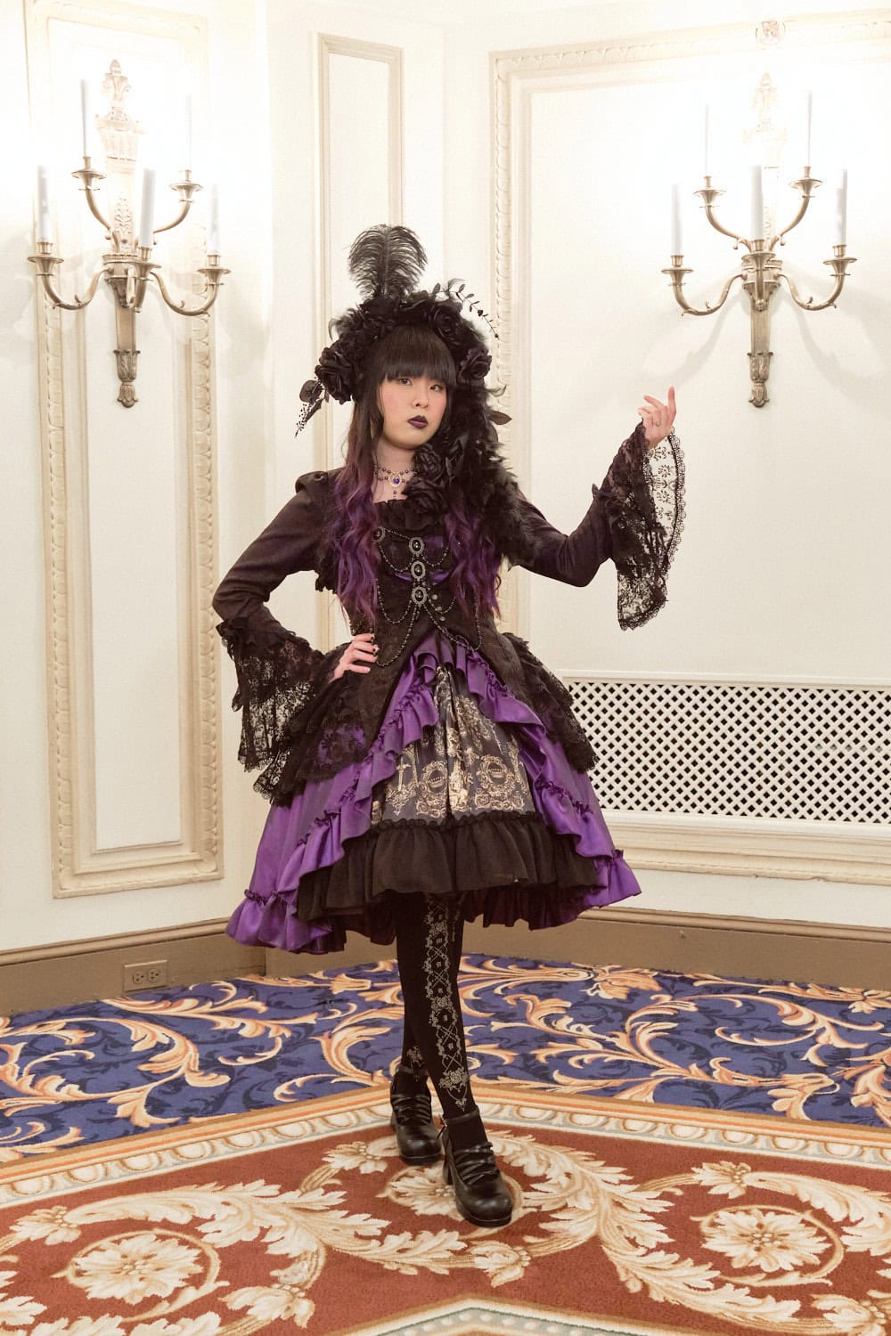 Gothic lolita wearing black, purple, and gold themed outfit featuring Atelier Pierrot and Haenuli collaboration dress.