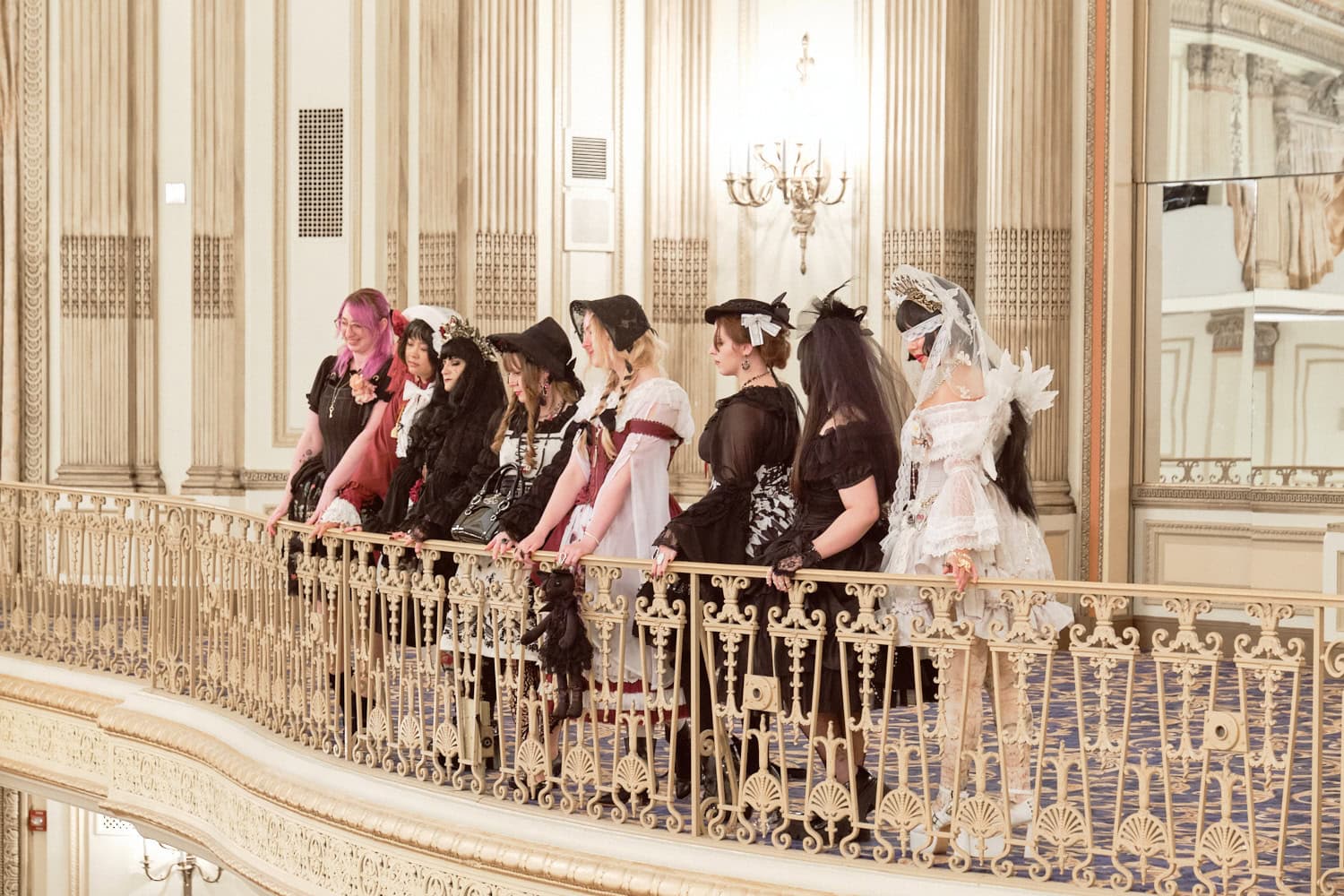 Group of lolitas on balcony looking down.