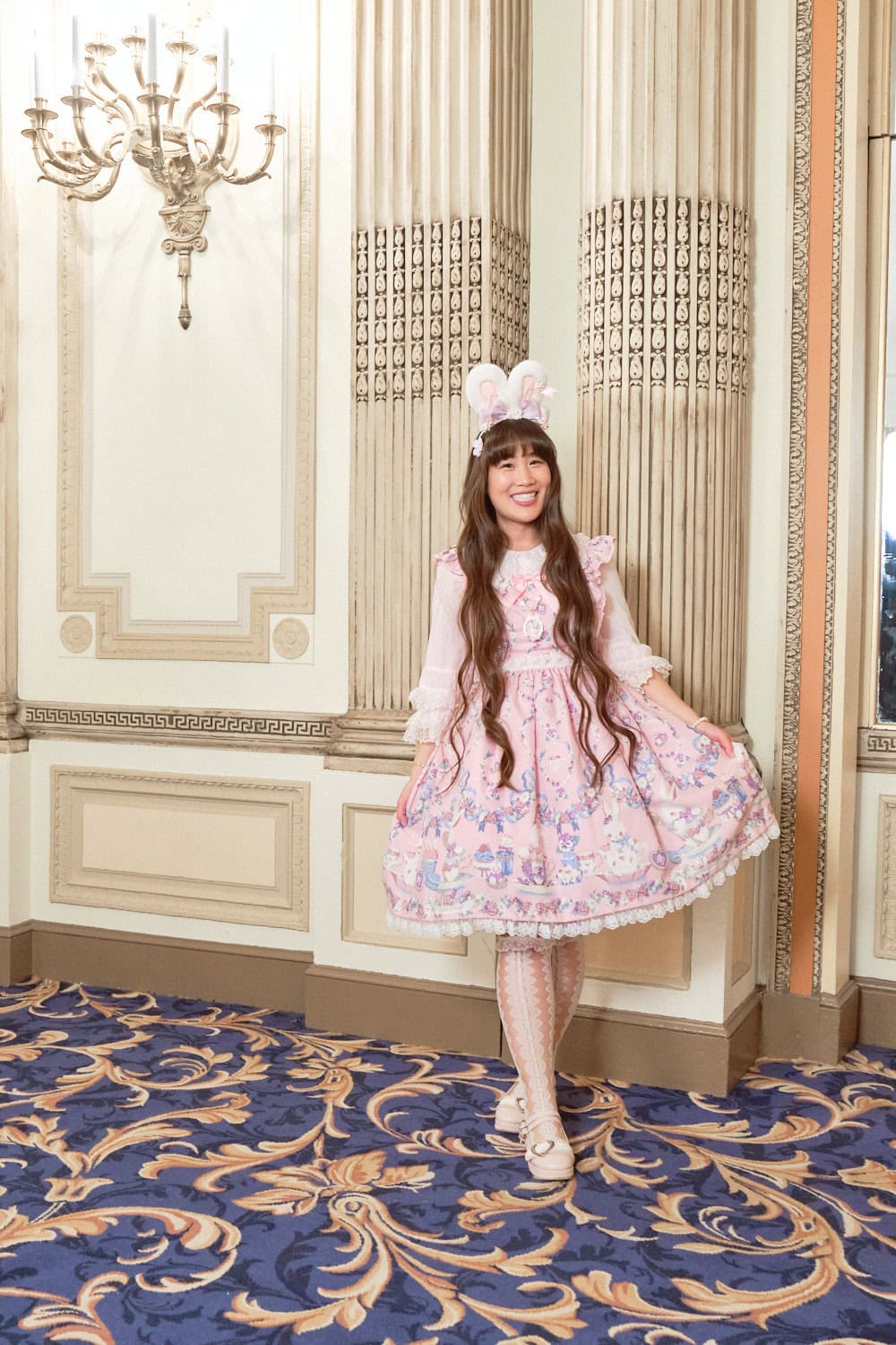 Sweet lolita wearing bunny ears and pink bunny themed dress by Angelic Pretty.