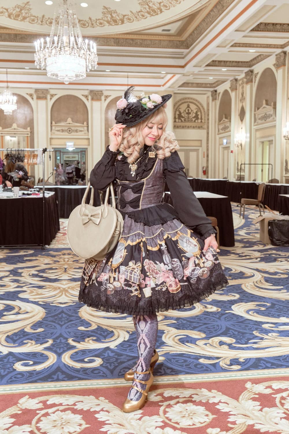 Classic lolita wearing grey, black, and gold cosmetics print dress by Metamorphose.