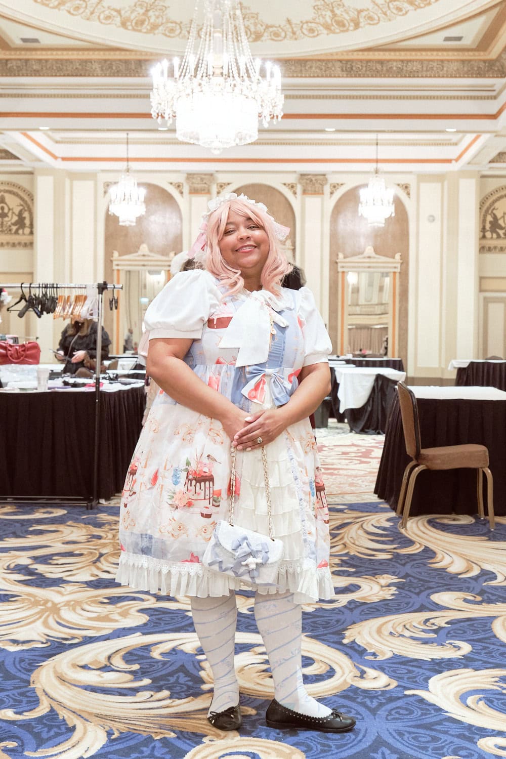 Sweet lolita with pink hair wearing sax and white dessert themed dress.
