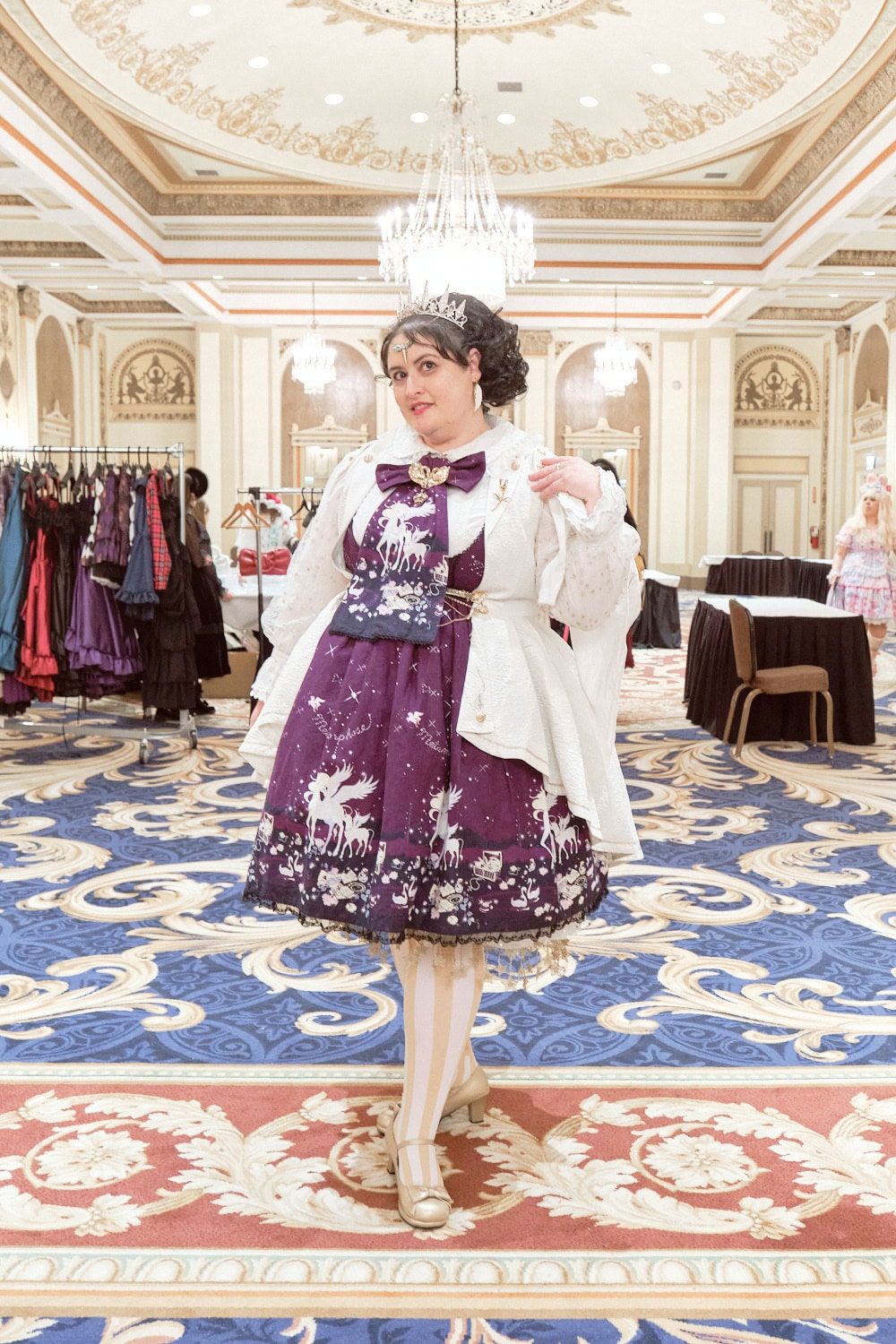 Classic lolita wearing tiara, white coat, purple unicorn print dress by Metamorphose.