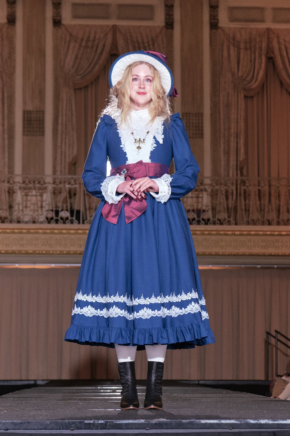 Model 5 weaering blue and red historically inspired classic lolita by Hoshibako Works.
