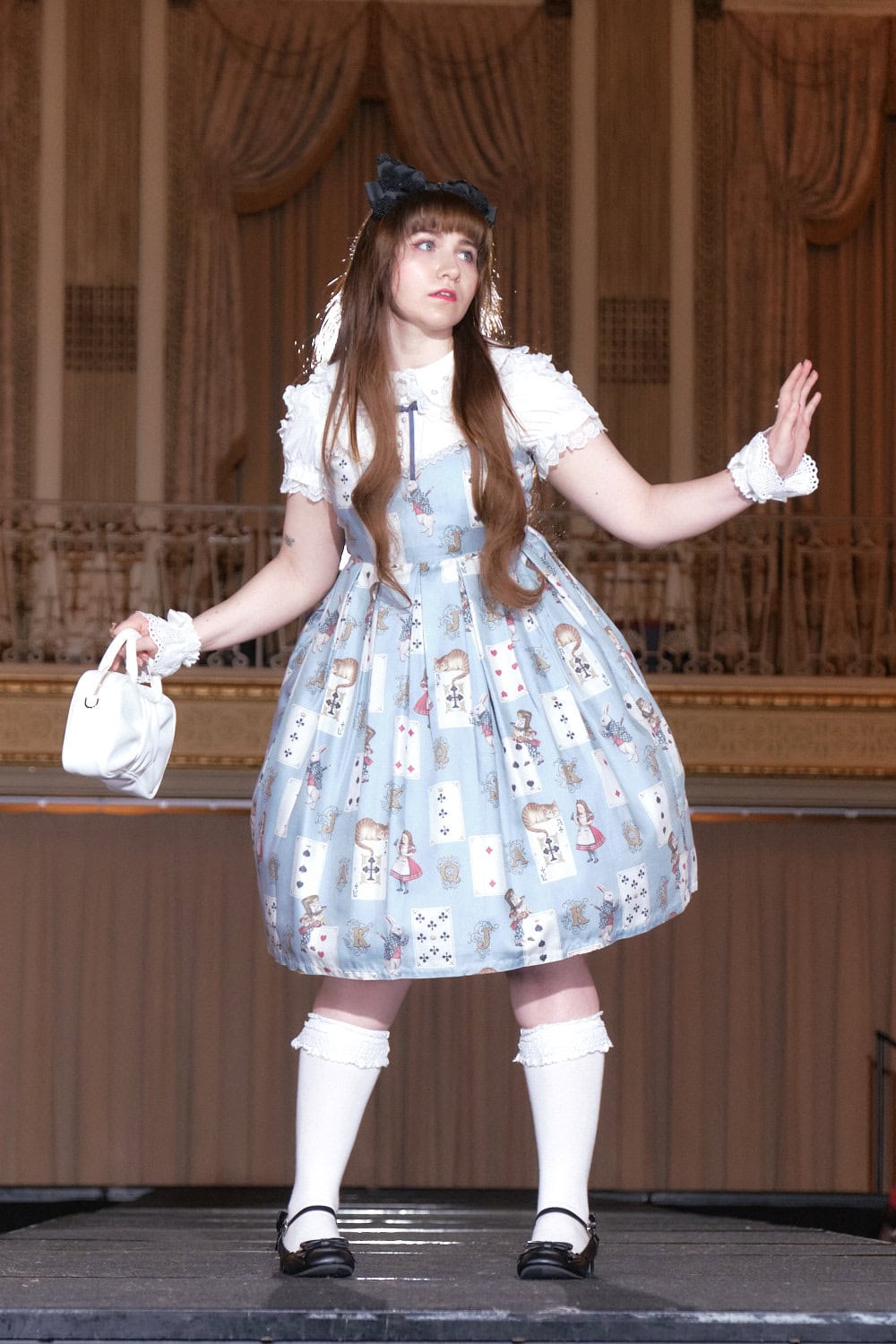 Model 9 wearing light blue Alice in Wonderland and playing cards printed dress from Emily Temple Cute.