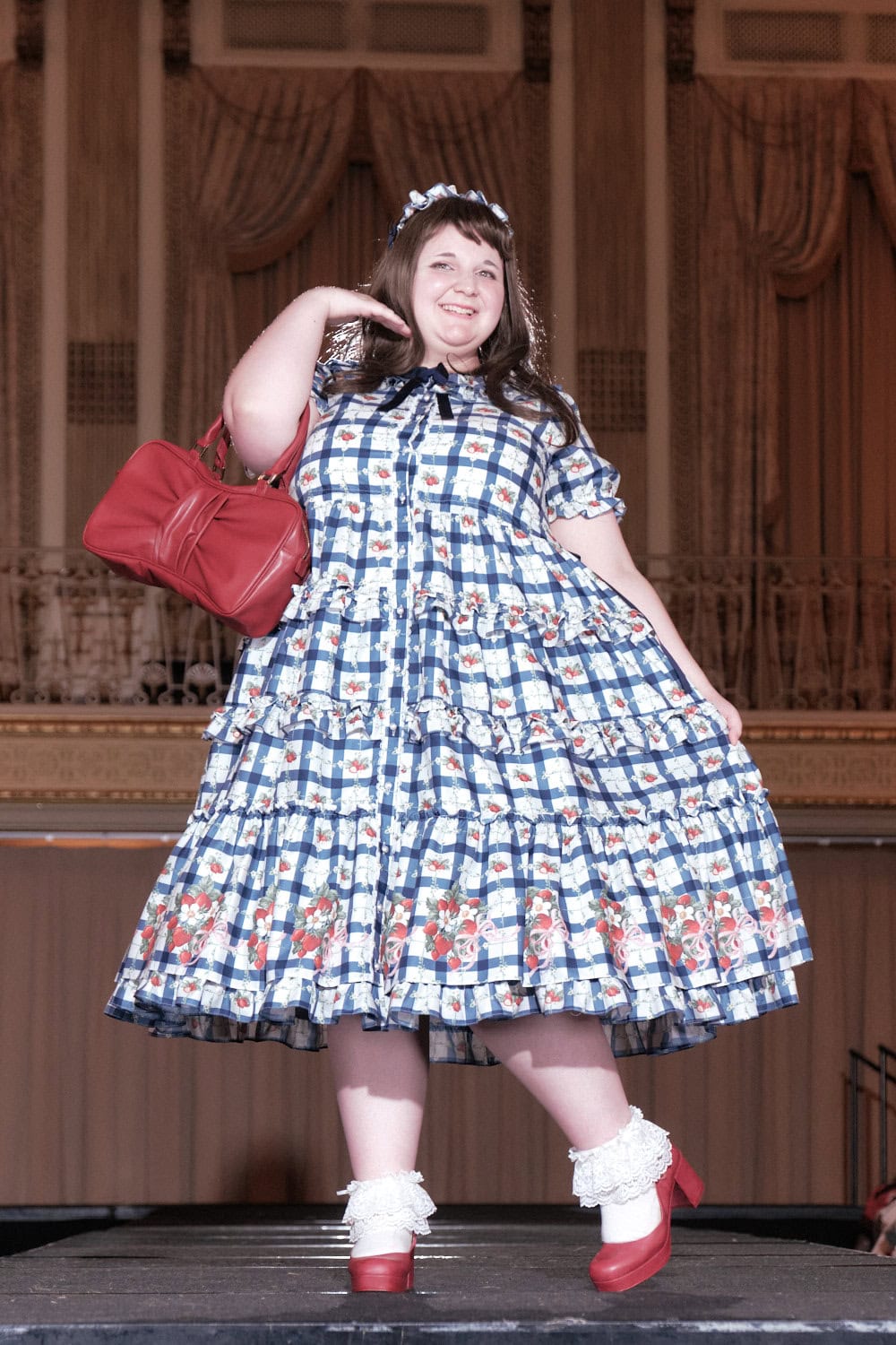 Model 10 wearing strawberry and blue plaid print short sleeve mid calf length dress by Emily Temple Cute.