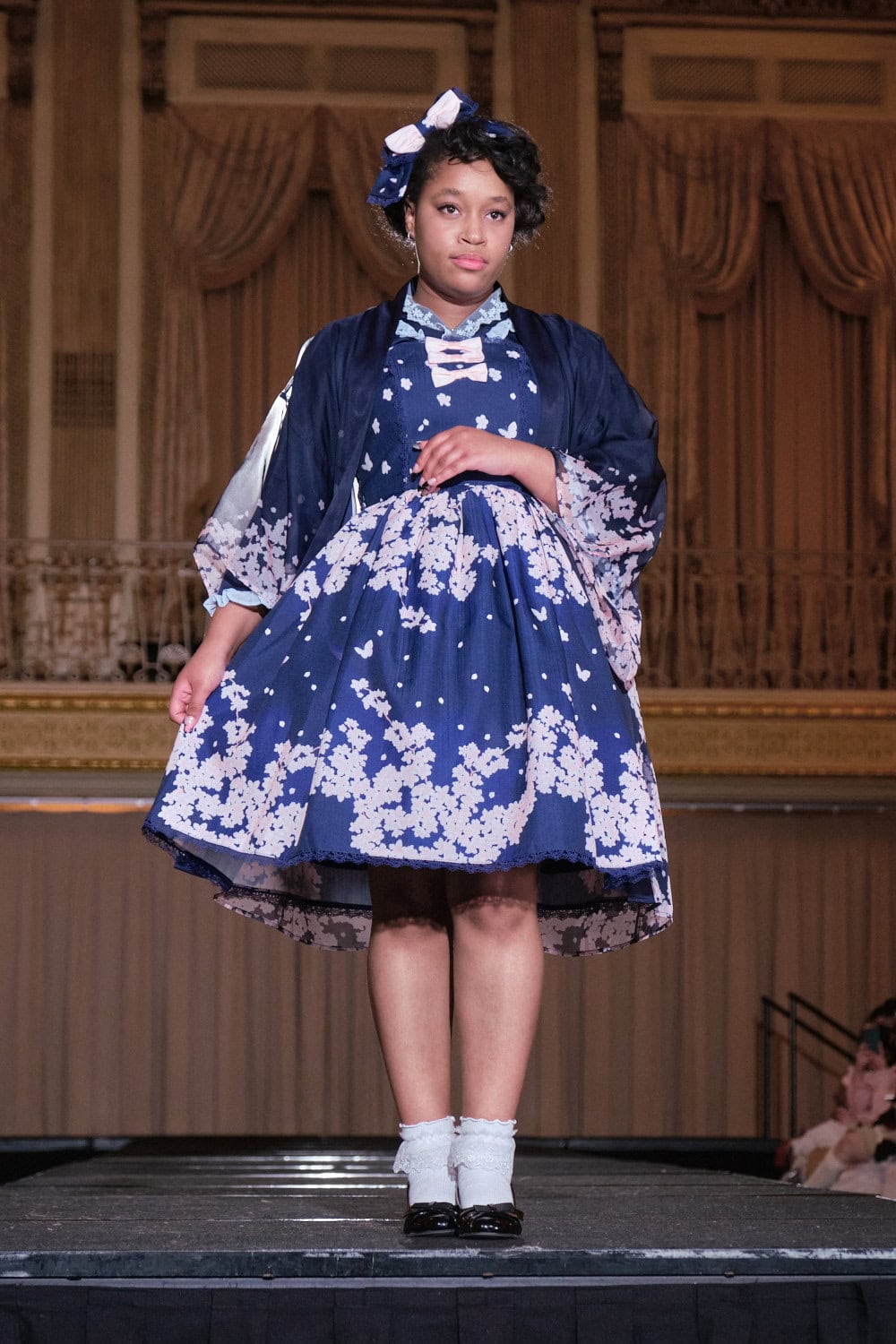 Model 15 wearing navy and pink cherry blossom haori jacket and matching dress by Axes Femme Kawaii.