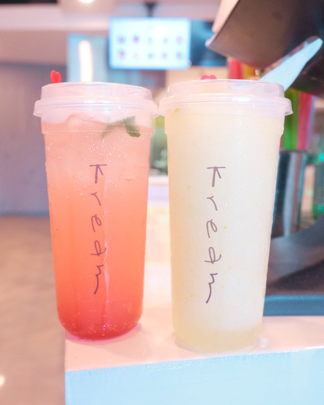 2 iced drinks on countertop. Left is strawberry mojito. Right is yuzu lemonade.