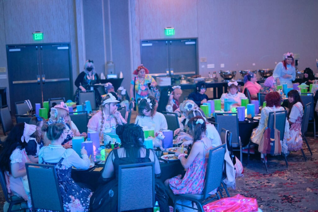 Multiple party tables with attendees sitting,