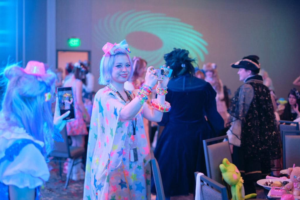Model Haruka Kurebayashi taking a photo with cell phone.