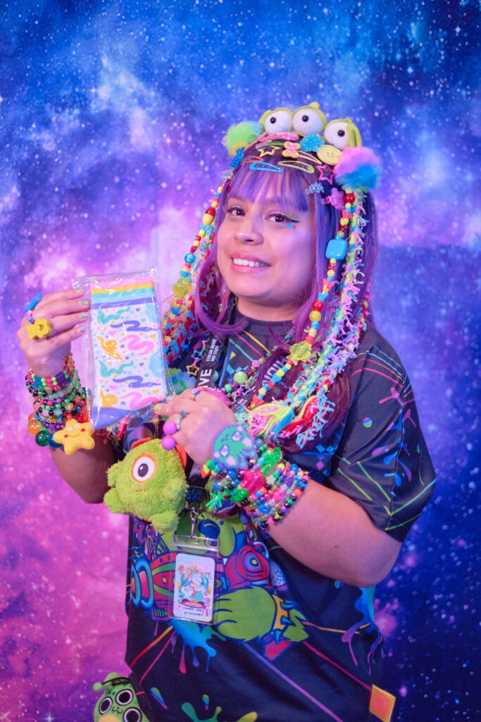 Raffle prize winner holding MintyMix worm on a string socks.