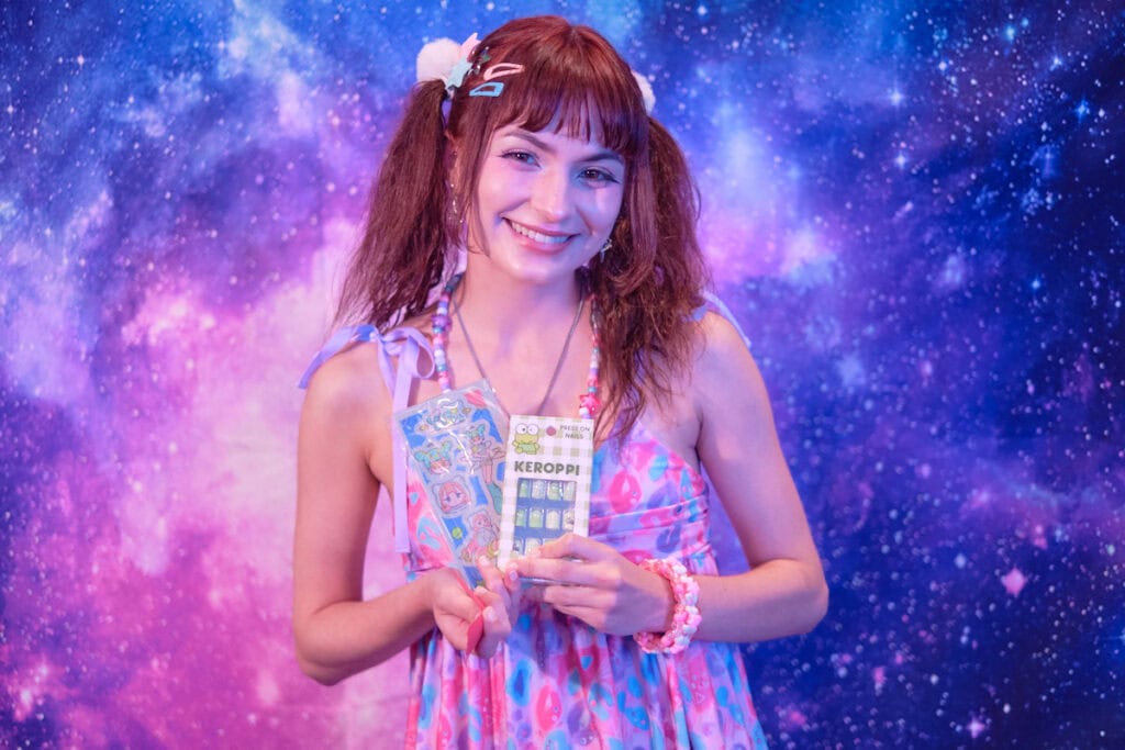 Raffle prize winner holding stickers and Keroppi nail stickers.