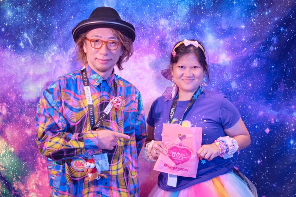Designer Sebastian Masuda standing with raffle prize winner 3.