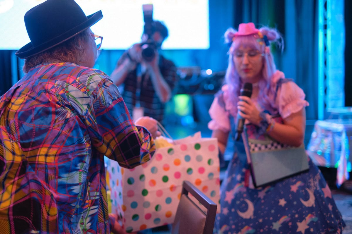 Designer Sebastian Masuda receiving polka dot gift bag.