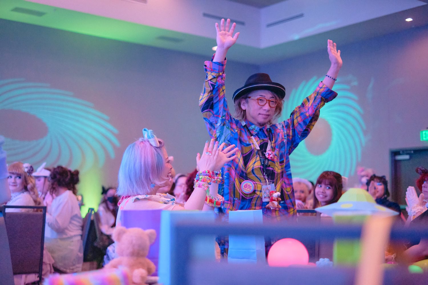 Sebastian Masuda standing up and raising arms for round of applause.