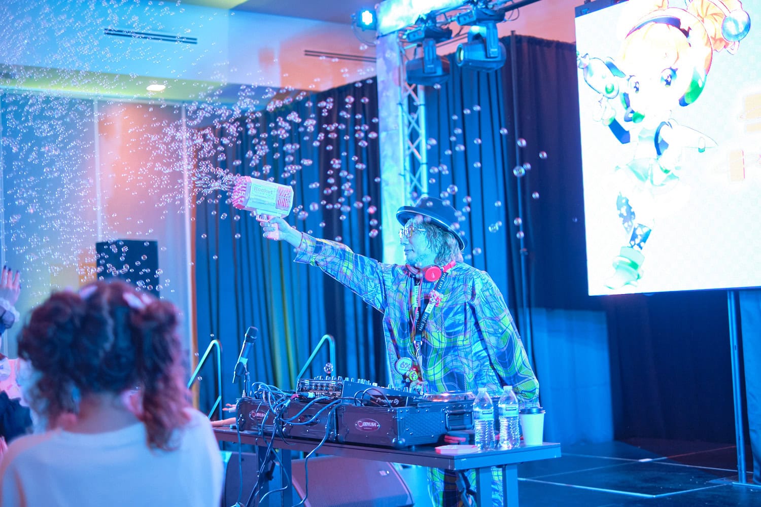 Sebastian Masuda shooting soap bubbles with bubble gun into crowd.
