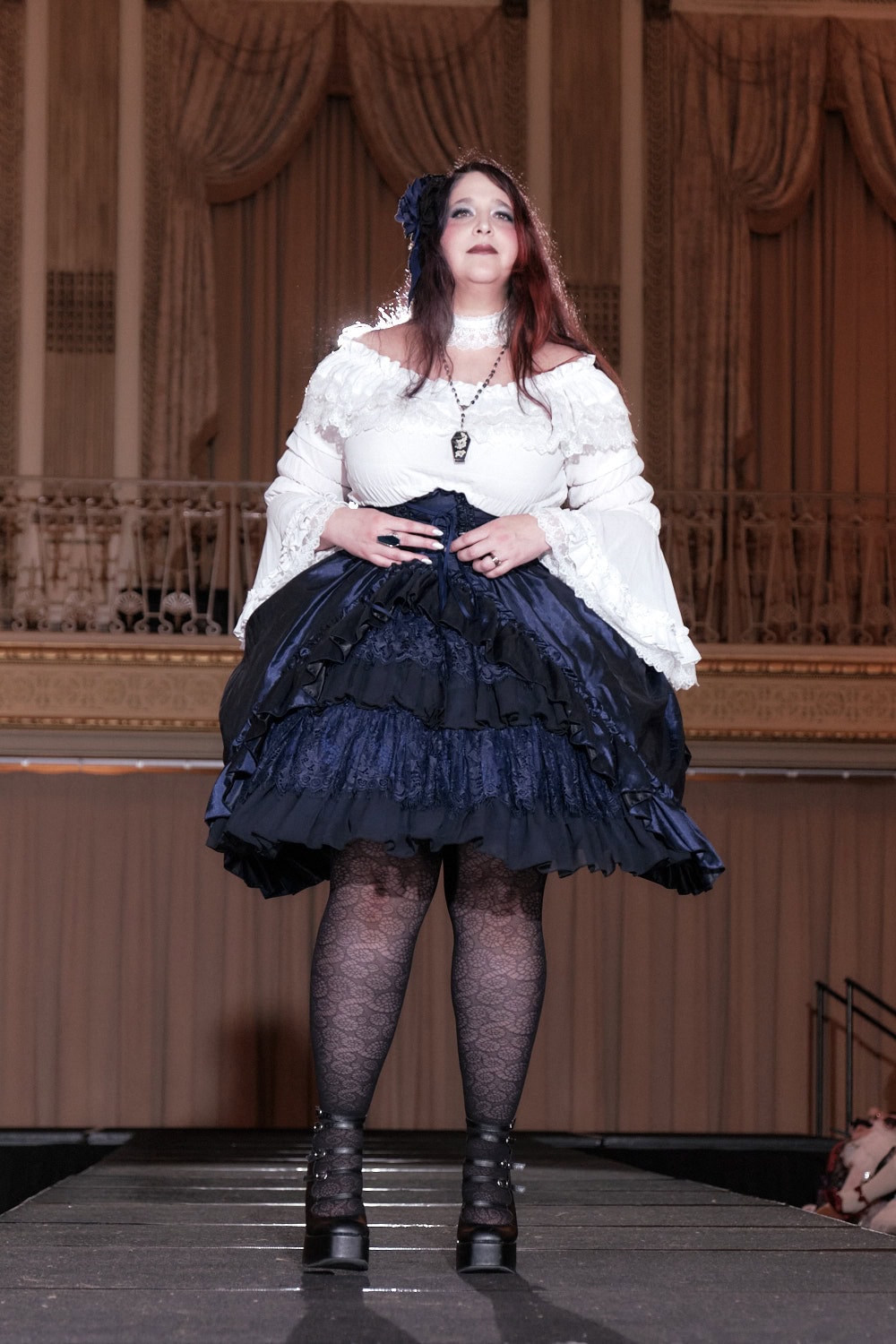 Model 6 wearing a white and navy lolita outfit. The model wears a white choker, white long sleeve blouse, and navy shantung high waist skirt.