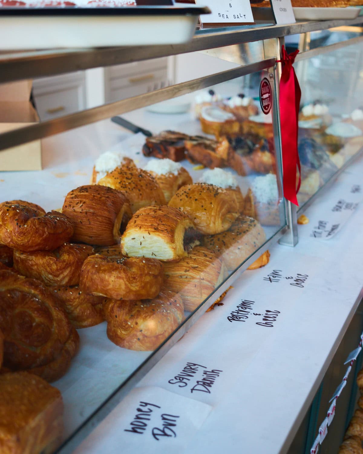 Bandit Patisserie pastry display with savory danish, pastrami and cheese croissant, honey bun, and ham and cheese croissant