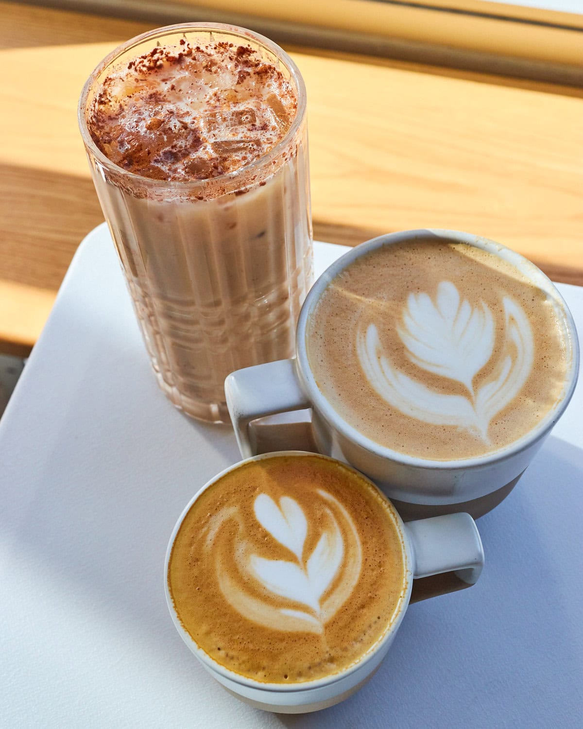 top down view cala coffee downtown single origin flat white, latte, and chai latte