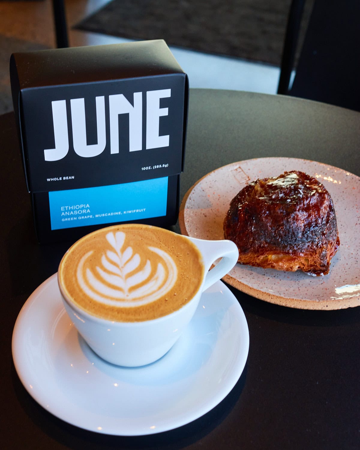 June flat white and kouign amann from Last Call Baking Company with a box of June single origin Ethiopian coffee beans