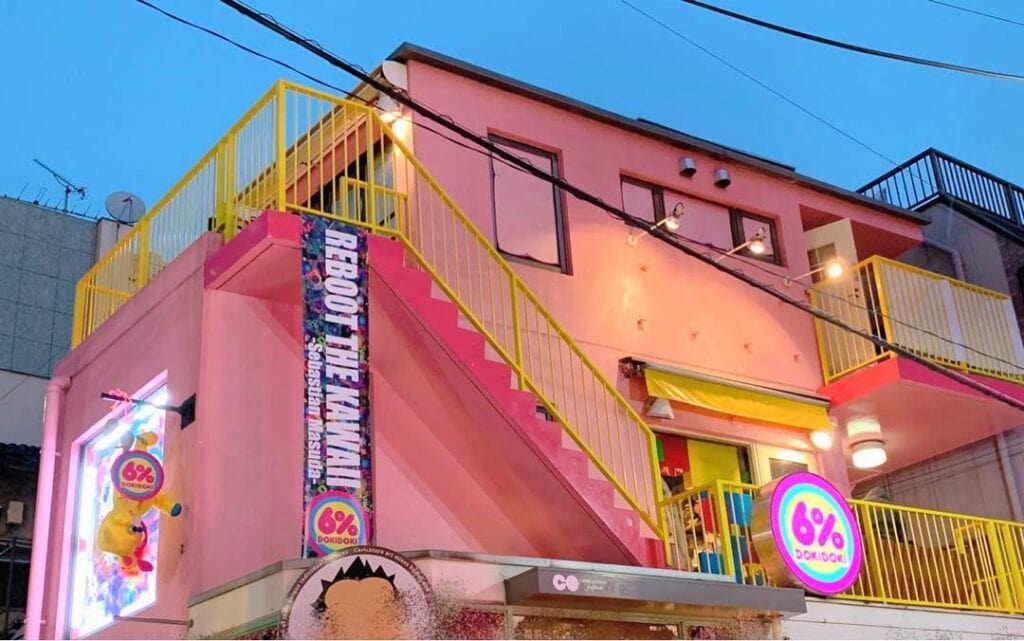 6%dokidoki shop exterior taken from the streets of Harajuku. The building is pink with yellow stairs.