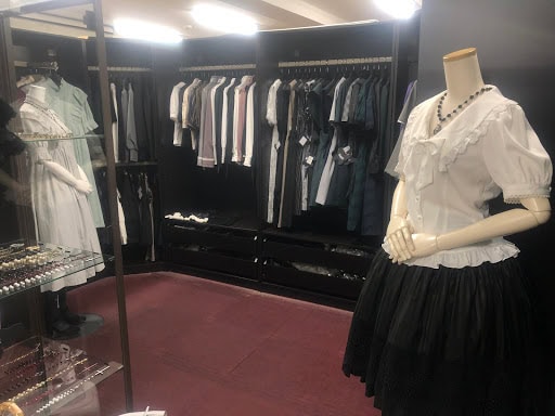 Interior of the Sheglit shop. The mannequin on the right side wears a white blouse and black lolita skirt.