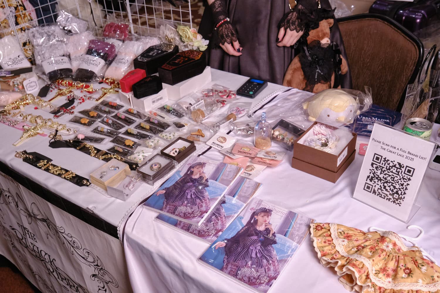 The Black Ribbon's booth featuring socks, jewelry and magazines.
