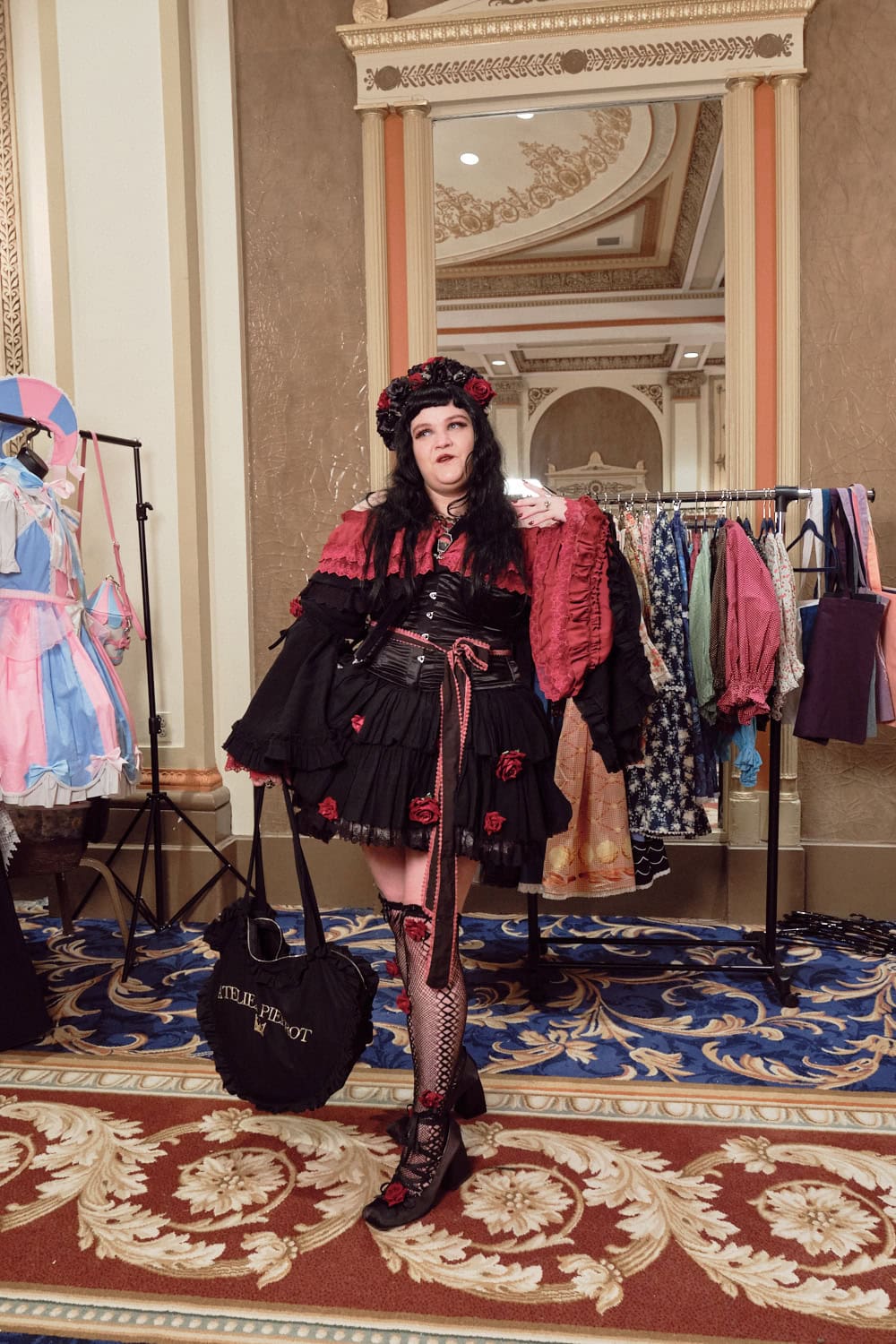Attendee wearing black and red roses gothic lolita outfit featuring Atelier Pierrot pieces.