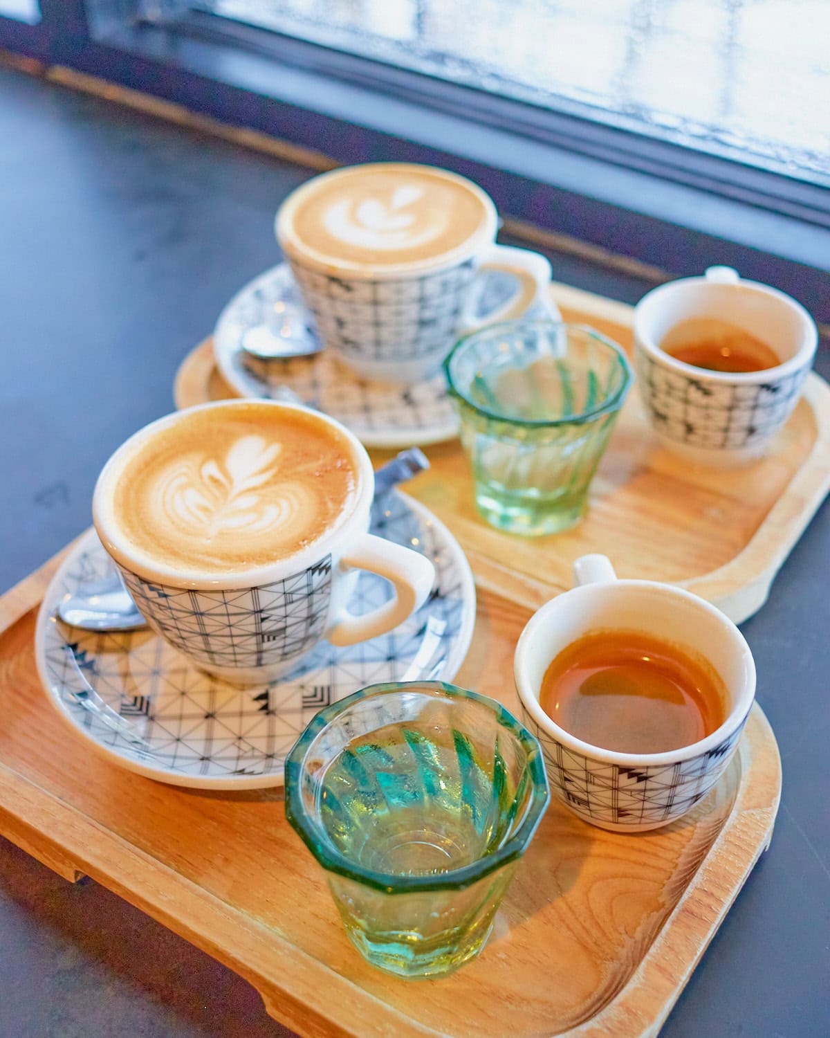 Blacksmith competition cappuccino with a shot of espresso and a side car of bubbly water on a trey